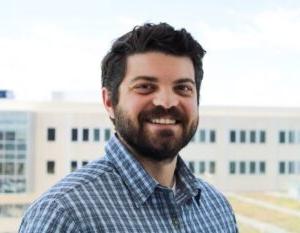 Man smiling in blue shirt